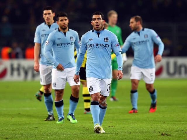 Carlos Tevez leads Manchester City from the pitch