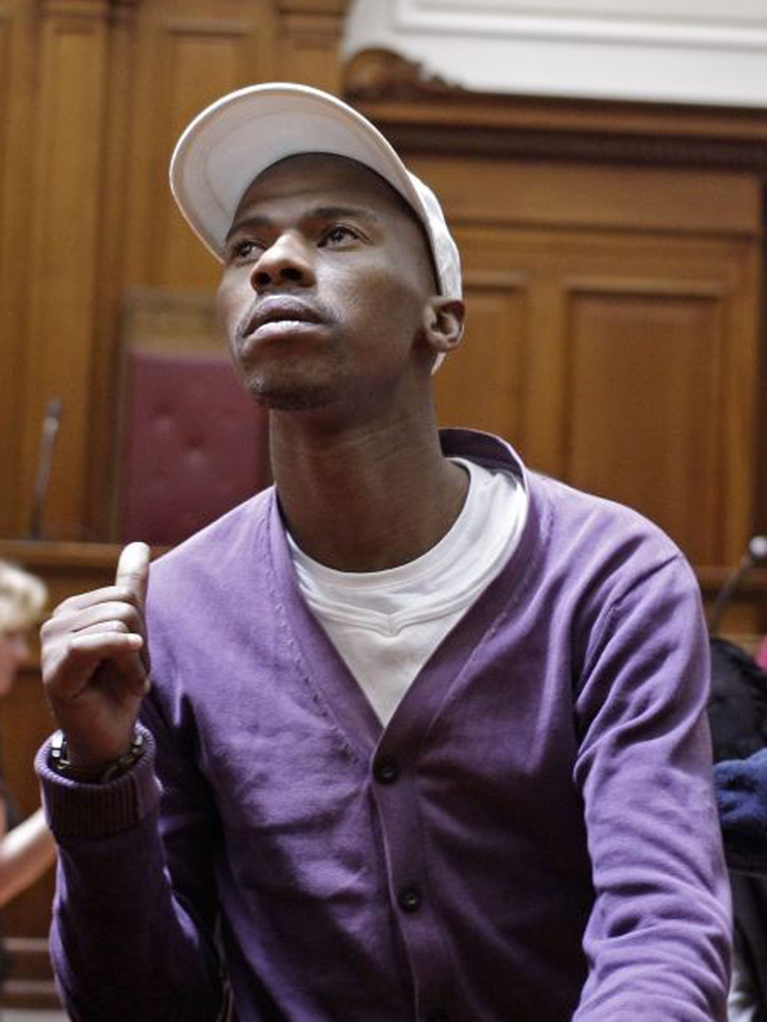 Xolile Mngeni signals a thumbs-up to his family as he is sentenced to life in prison