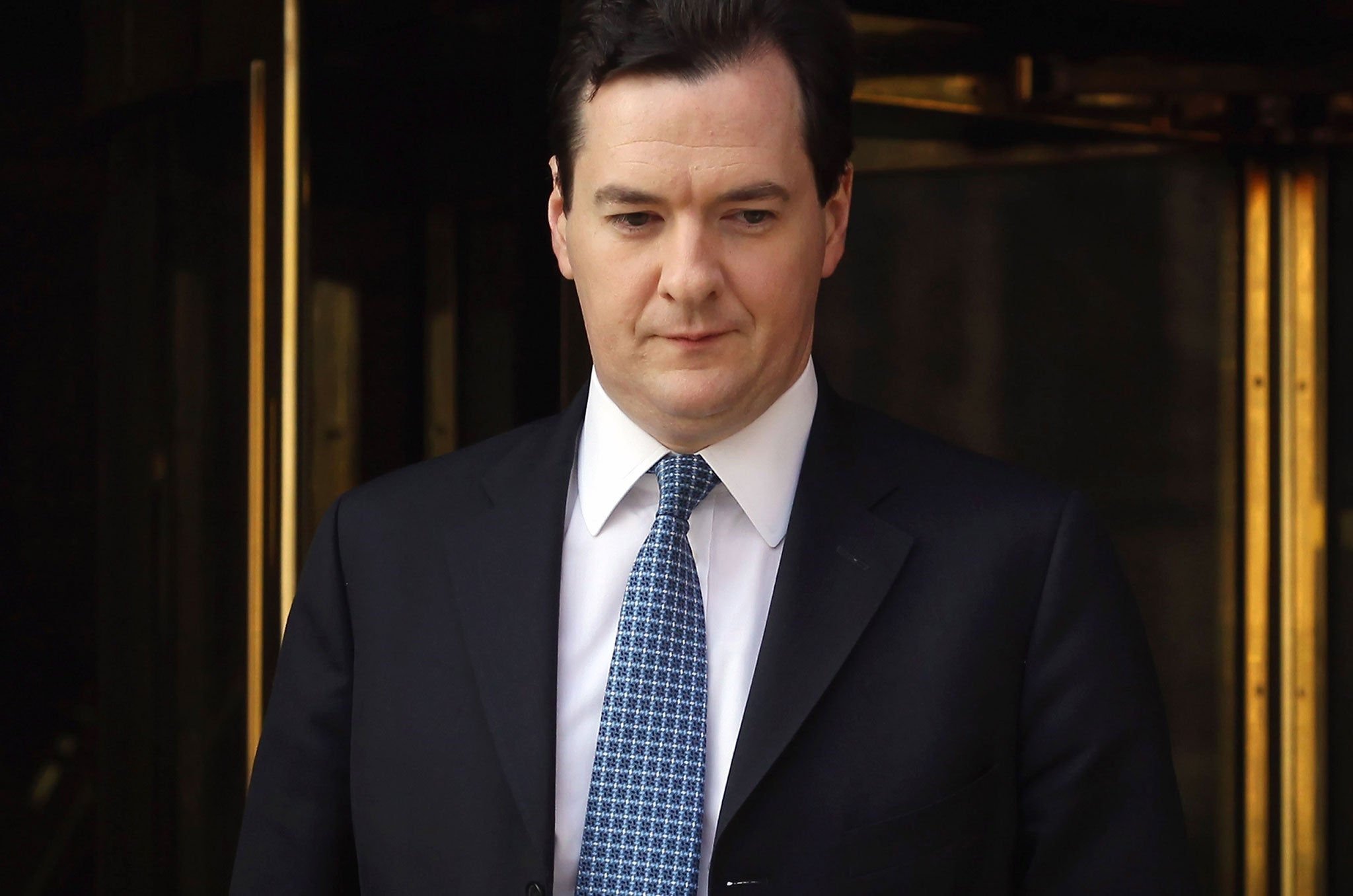 Chancellor of the Exchequer George Osborne leaves Millbank studios after a series of radio interviews on March 22, 2012 in London, England.