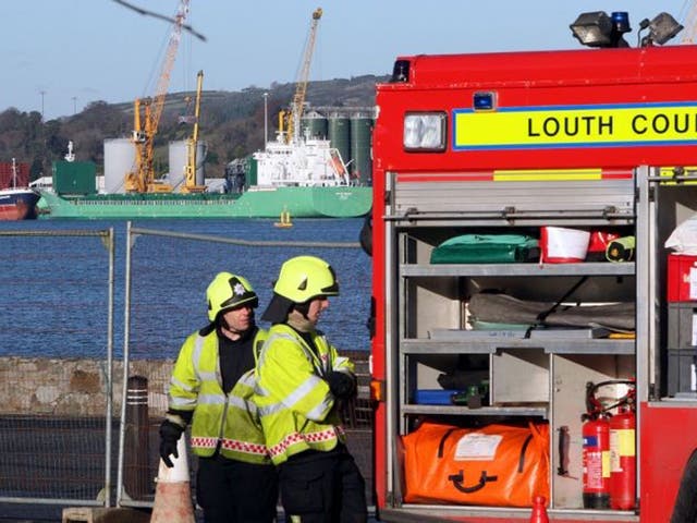 Firemen from  Omeath in Co Louth, monitor the MV Arklow Meadow, which remains cordoned off at Warrenpoint harbour