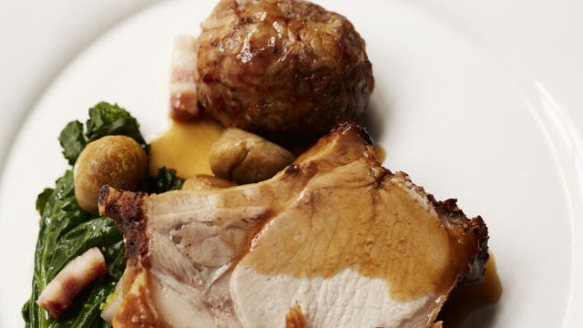 Roast rib of pork with apple dumplings, greens and chestnuts with easy-to-prepare gravy