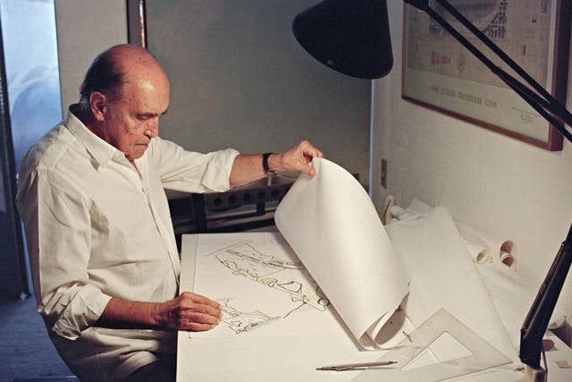 Brazilian architect Oscar Niemeyer looks at drawings for a project of two cities in Senegal, Africa in 1992. He was one of the world's most famous architects, and is particularly beloved in Brazil
