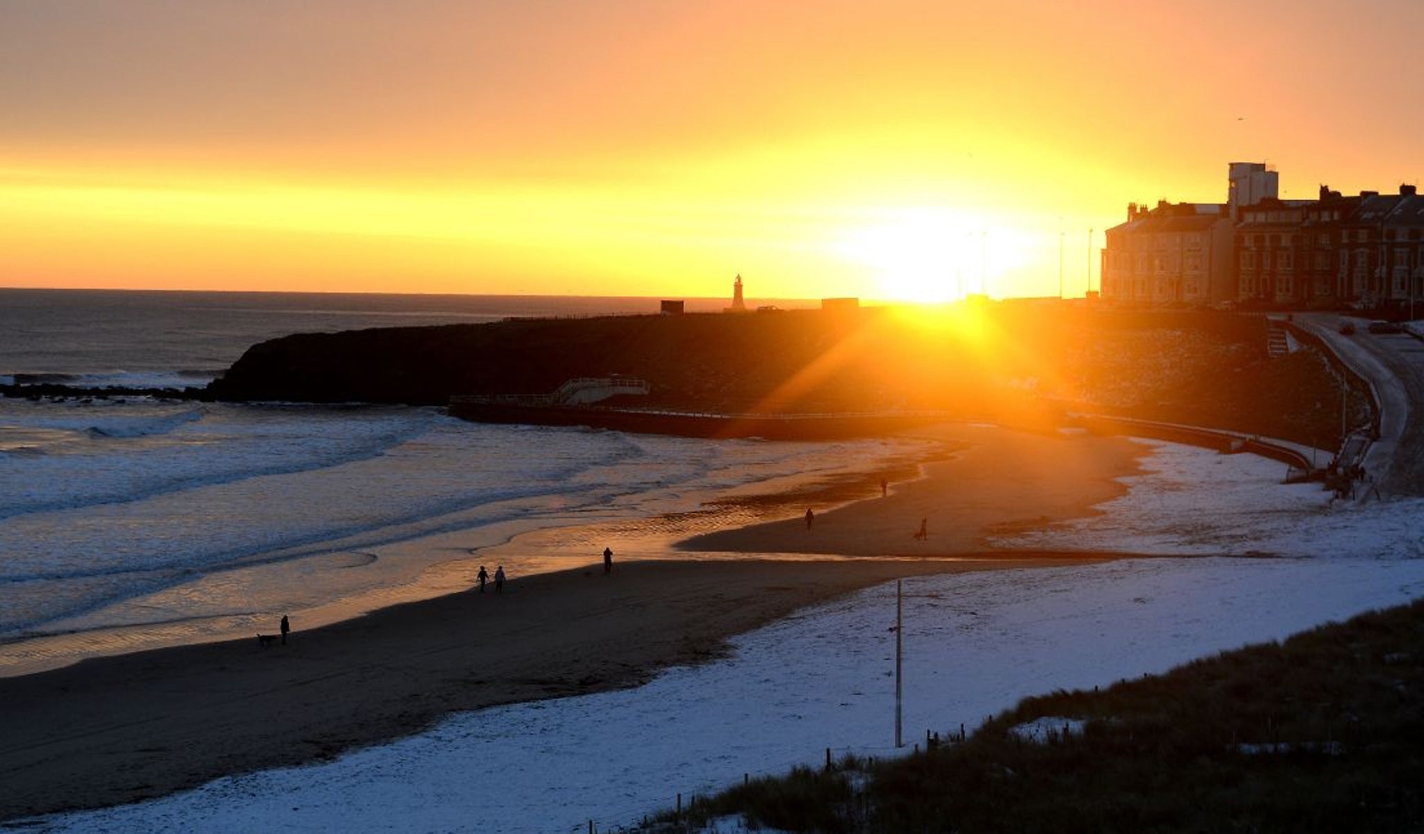 The sun rises over Tynemouth beach after a covering of snow