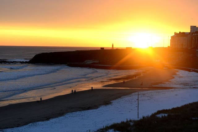 The sun rises over Tynemouth beach after a covering of snow
