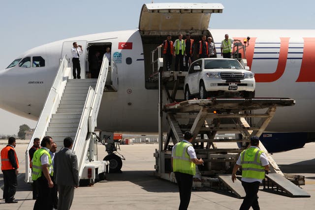 UN trucks are unloaded at Damascus airport