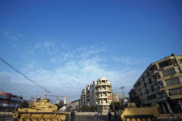 Egyptian army tanks deploy outside the presidential palace in Cairo on 8 December