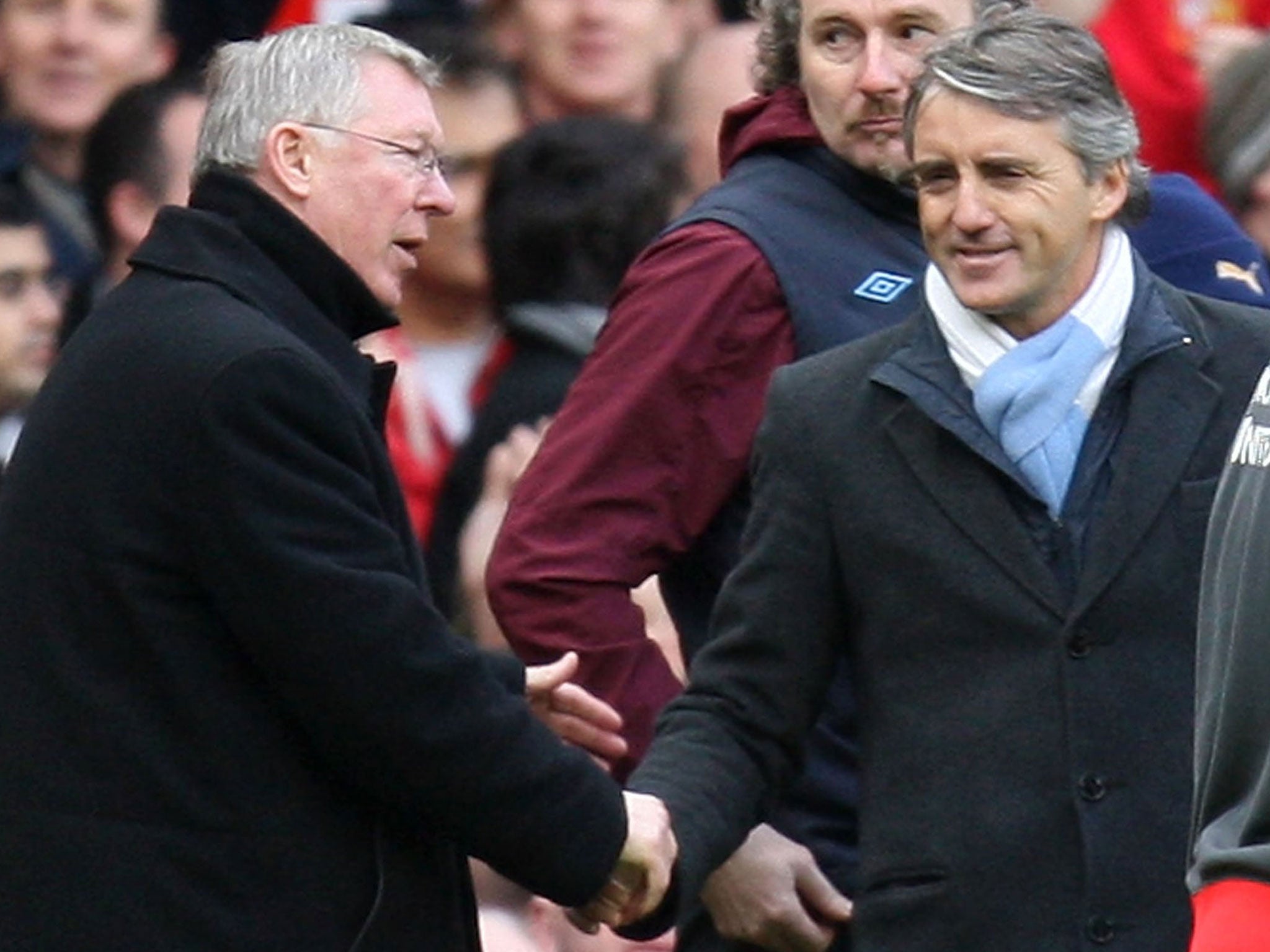 Surface tension: Sir Alex Ferguson and Roberto Mancini shake hands