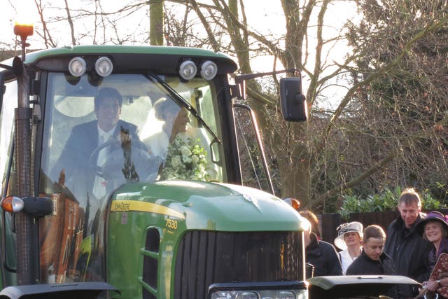 Plenty of welly: Alastair Cook draws admiring glances as he and his bride ride off in a tractor on their wedding day