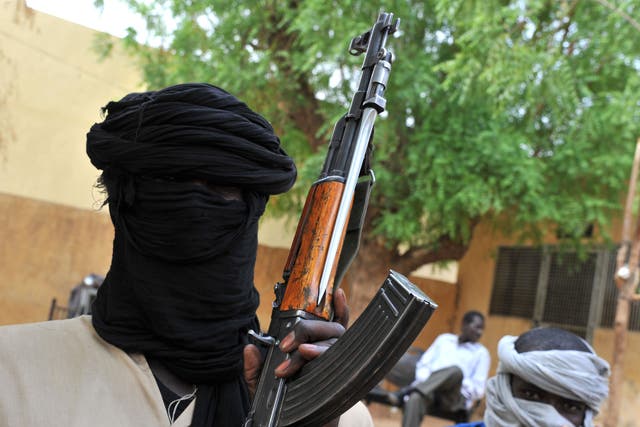 Fighters of the Islamist group Movement for Oneness and Jihad in West Africa (MUJAO) sitting in the courtyard of the Islamist police station in Gao. A group of armed youths has arrived in Gao from Burkina Faso, joining hundreds of other young African recr