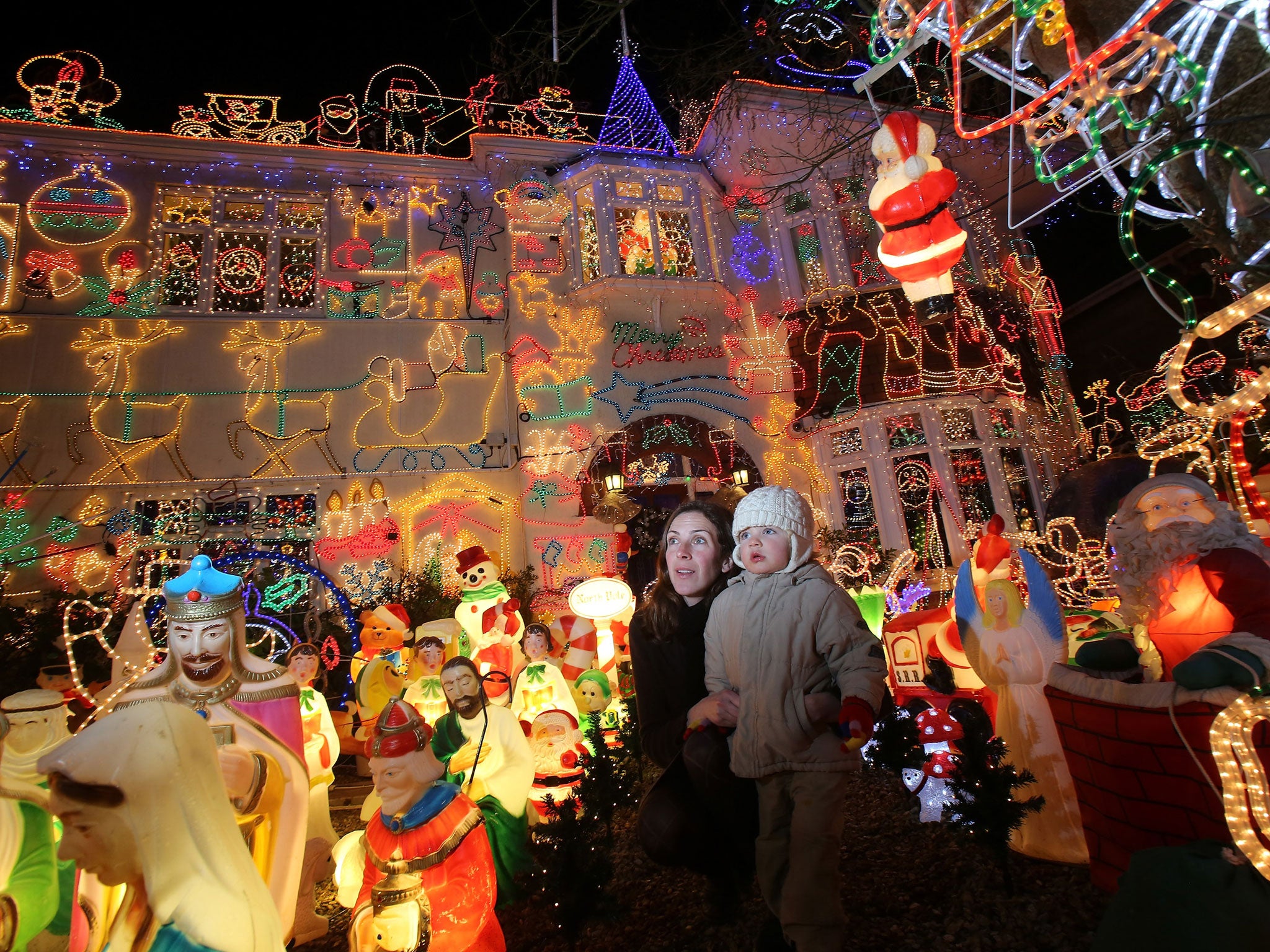 Anna Barclay and son Zac, 2, stop to look at Christmas festive lights that adorn a detached house in a suburban street in Melksham, December 8, 2012 in Melksham, England