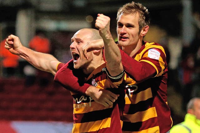 Gary Jones and James Hanson of Bradford celebrate following their victory in the penalty shootout 