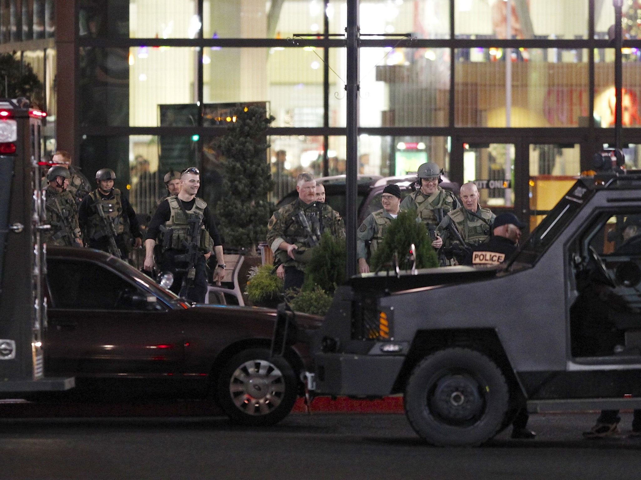 Police exit the Clackamas Town Centre shopping mall in Portland, Oregon