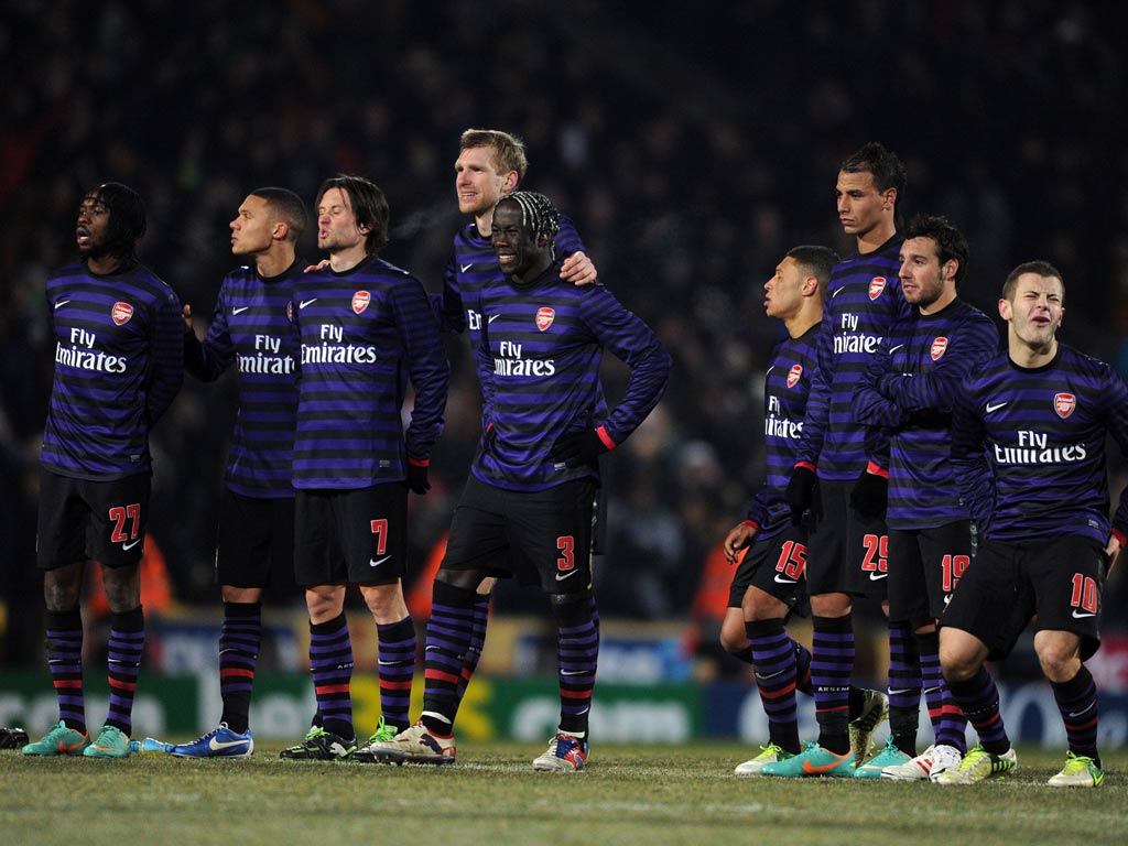 The Arsenal players look on during the penalty shoot-out