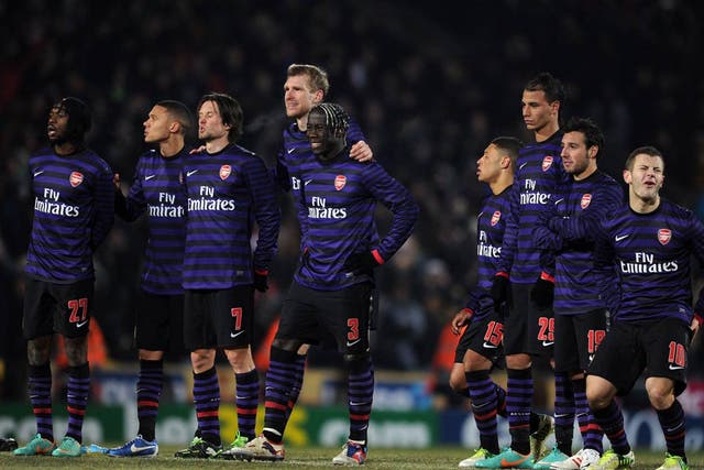 The Arsenal players look on during the penalty shoot-out