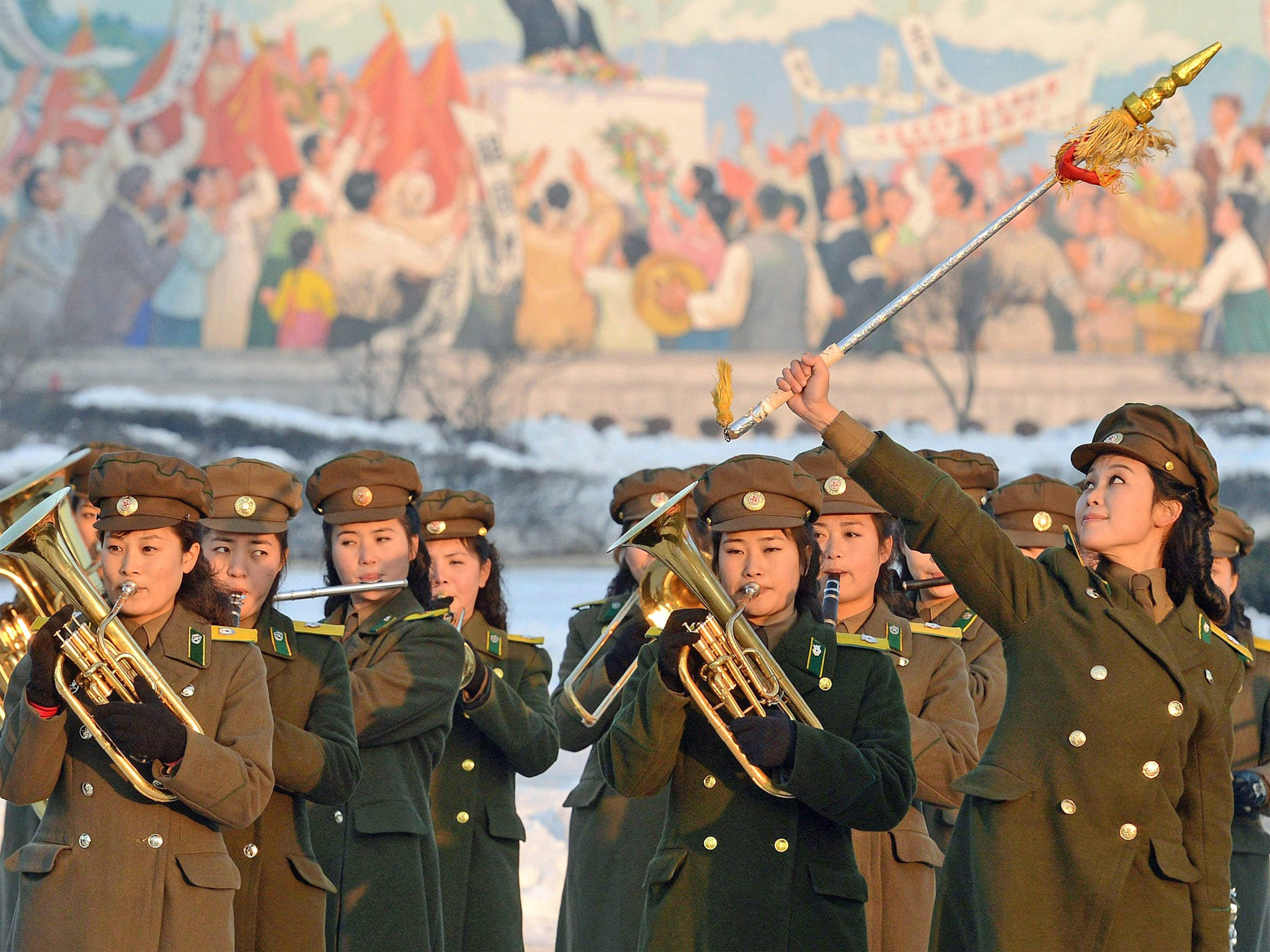 A North Korean military band in Pyongyang celebrates the successful launch of the long-range rocket yesterday