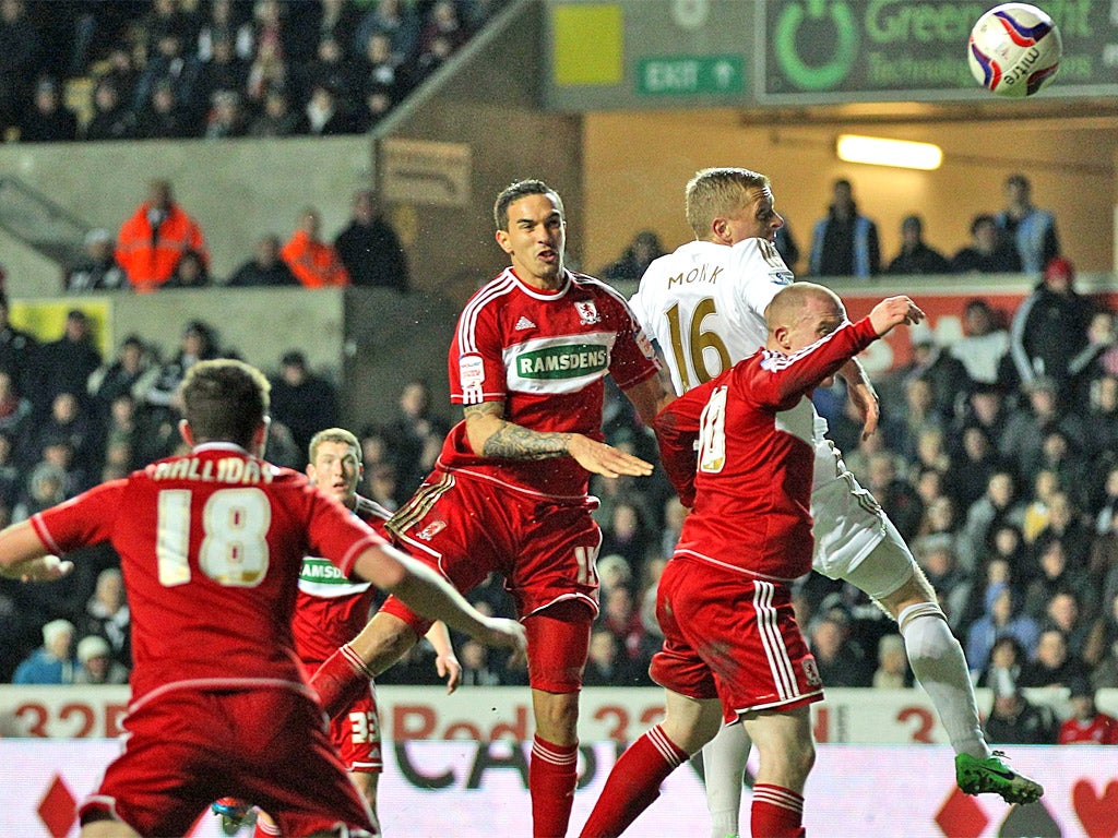 Boro’s Seb Hines, centre, scores an own goal while tussling with Gary Monk