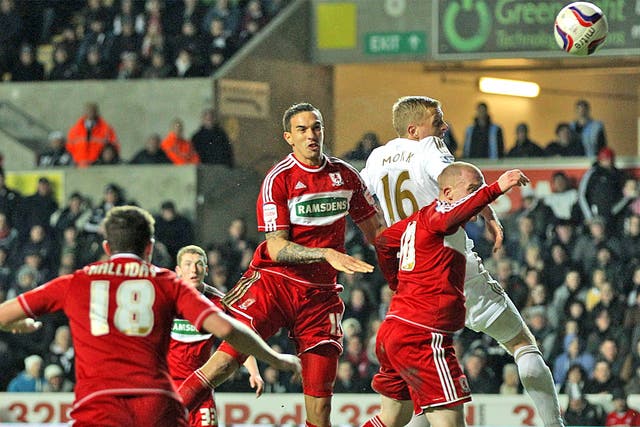 Boro’s Seb Hines, centre, scores an own goal while tussling with Gary Monk