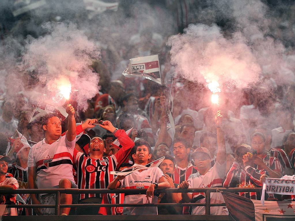 Supporters of Brazil’s Sao Paulo FC cheer for their team before their 2012 Copa Sudamericana final