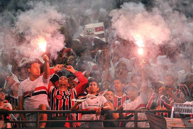 Supporters of Brazil’s Sao Paulo FC cheer for their team before their 2012 Copa Sudamericana final