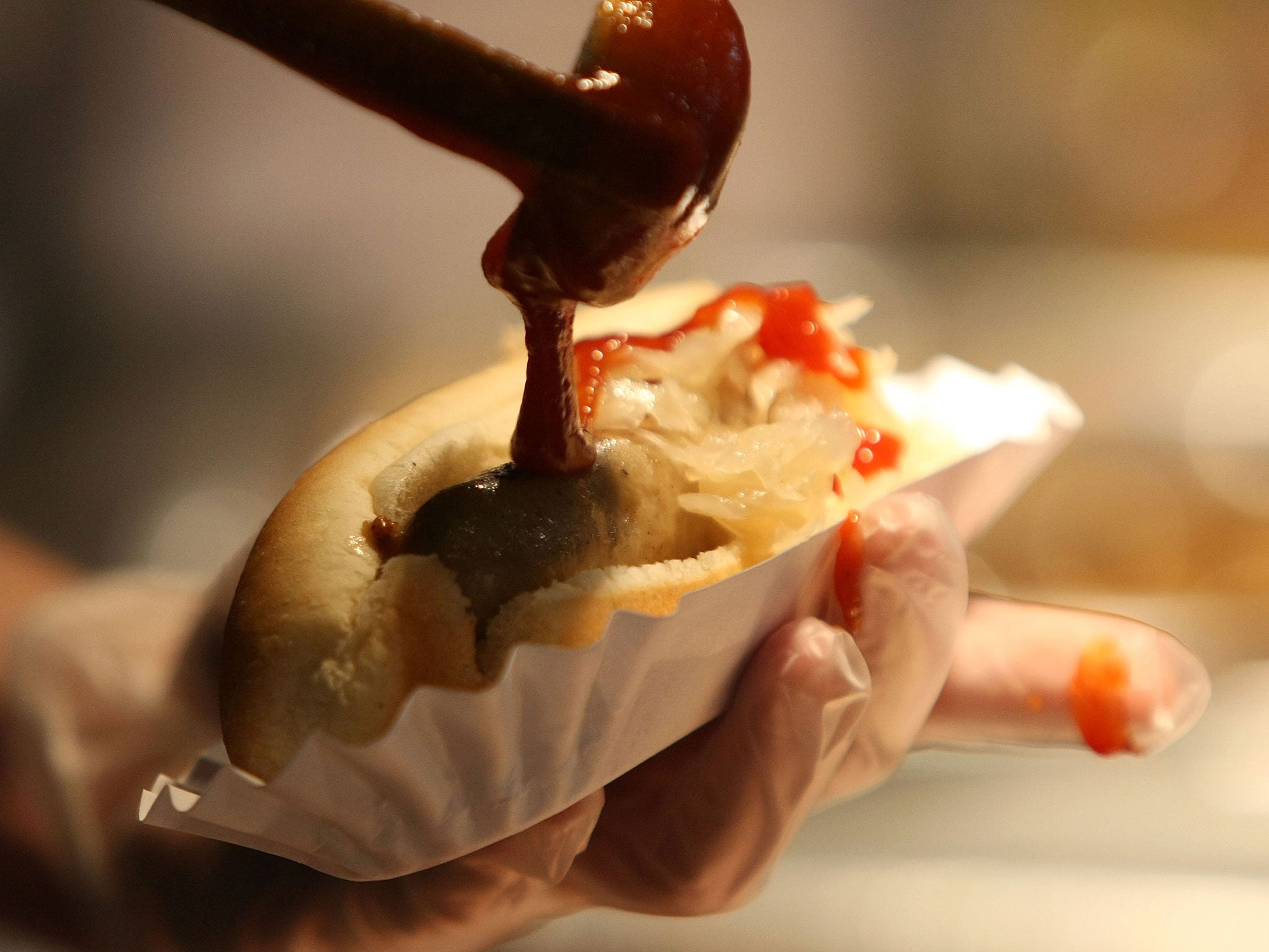 Sauce is poured onto a hot dog — but what lurks inside the sausage?