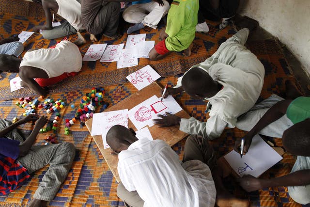 Children drawing in a Unicef-assisted transit centre for former child soldiers, in the town of Ndélé, capital of the northern Bamingui-Bangoran Prefecture