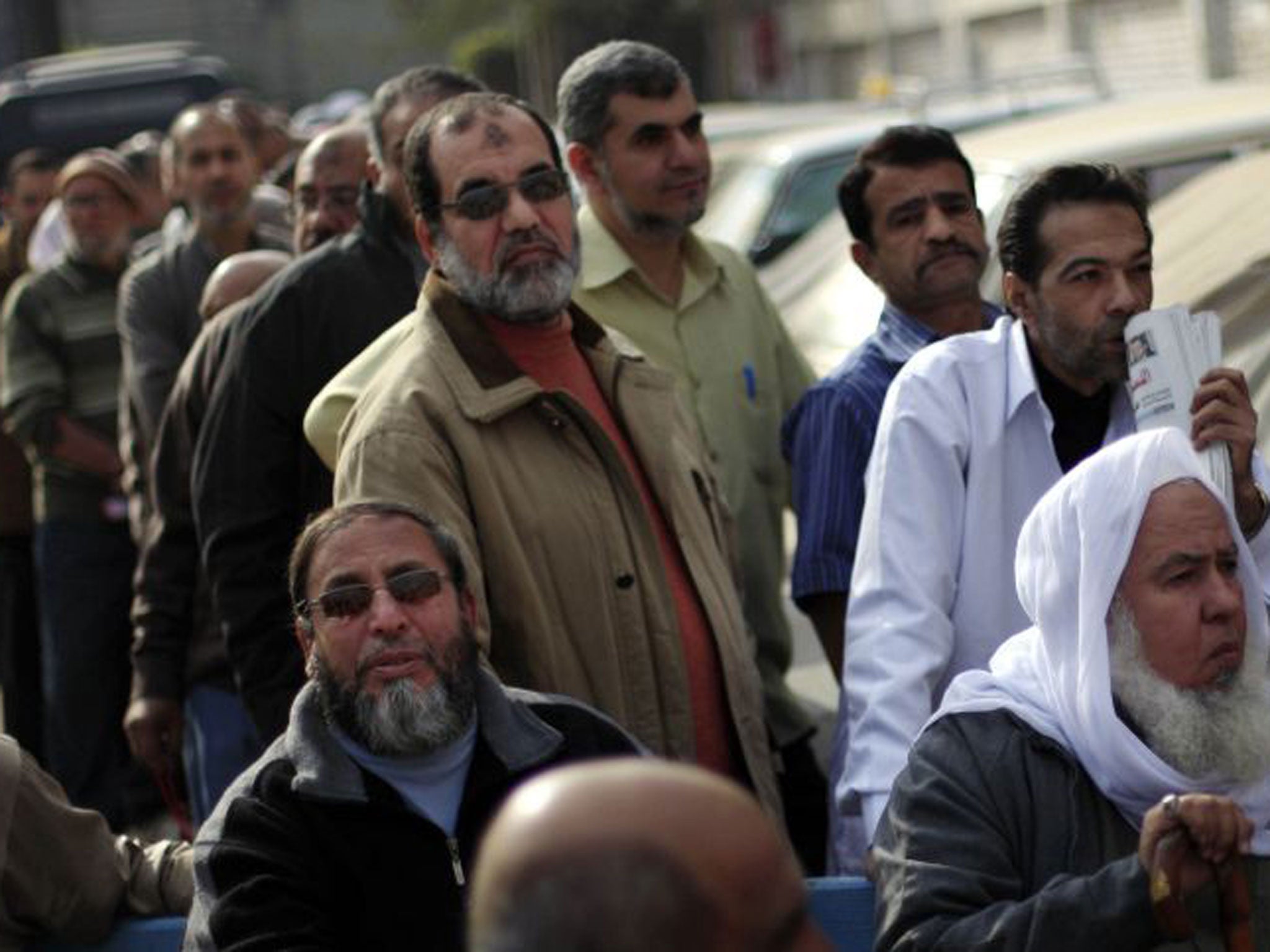 Egyptians wait to cast their votes outside a polling station