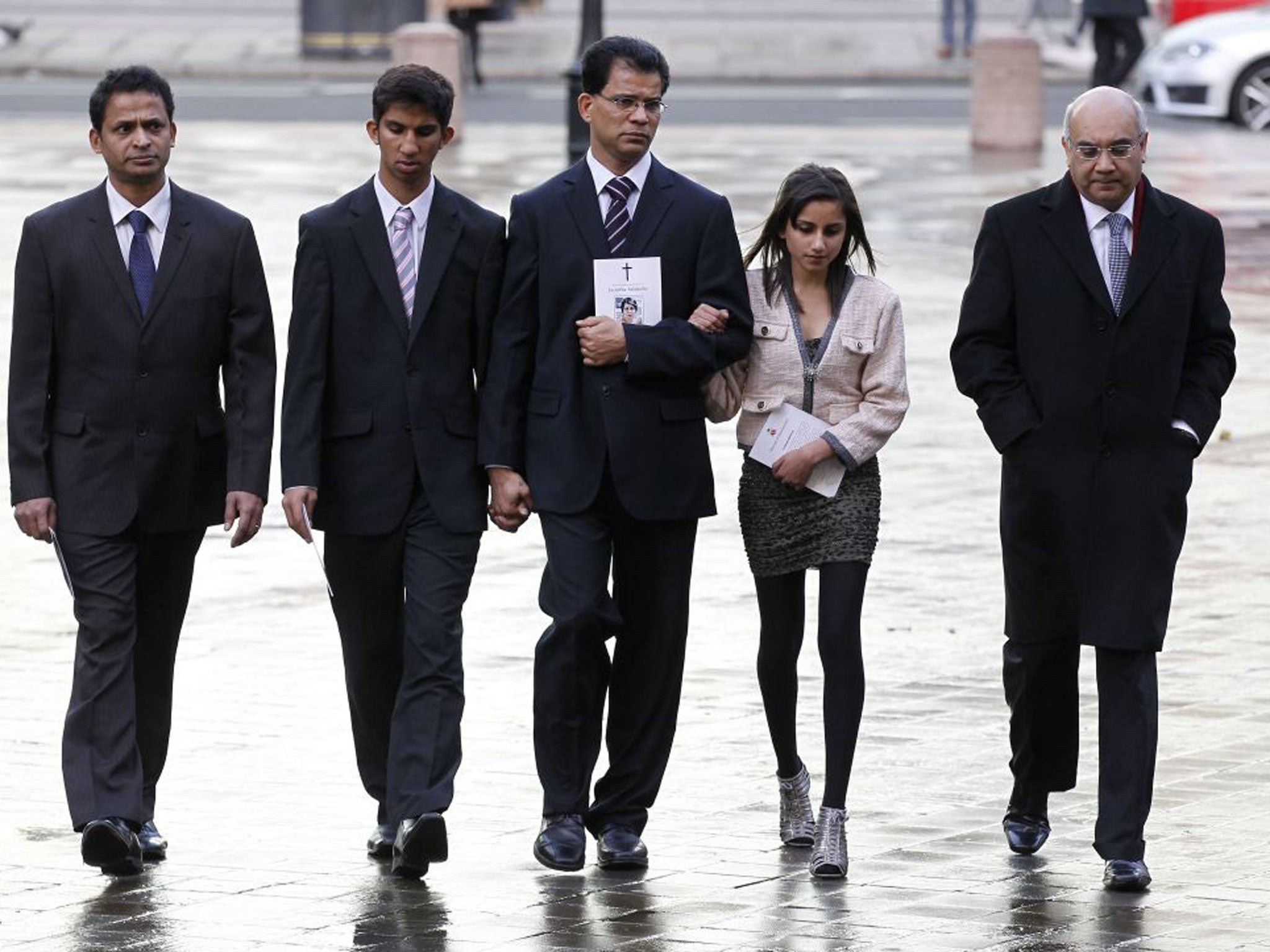 Husband of late Jacintha Saldanha, Benedict Barboza, centre, son Junal, 16, second left, daughter Lisha, 14, second right, accompanied by Keith Vaz MP, right, arrive at Westminster Cathedral for a memorial service