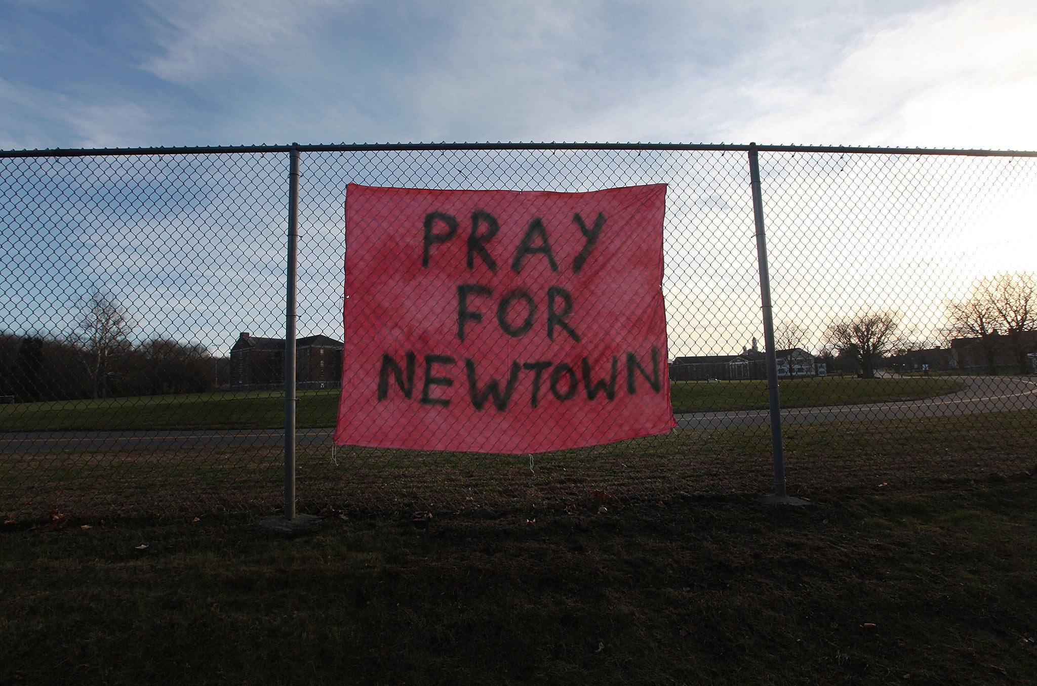 A handwritten sign reads 'Pray for Newtown' following the mass shooting at Sandy Hook Elementary School December 15, 2012 in Newtown, Connecticut.