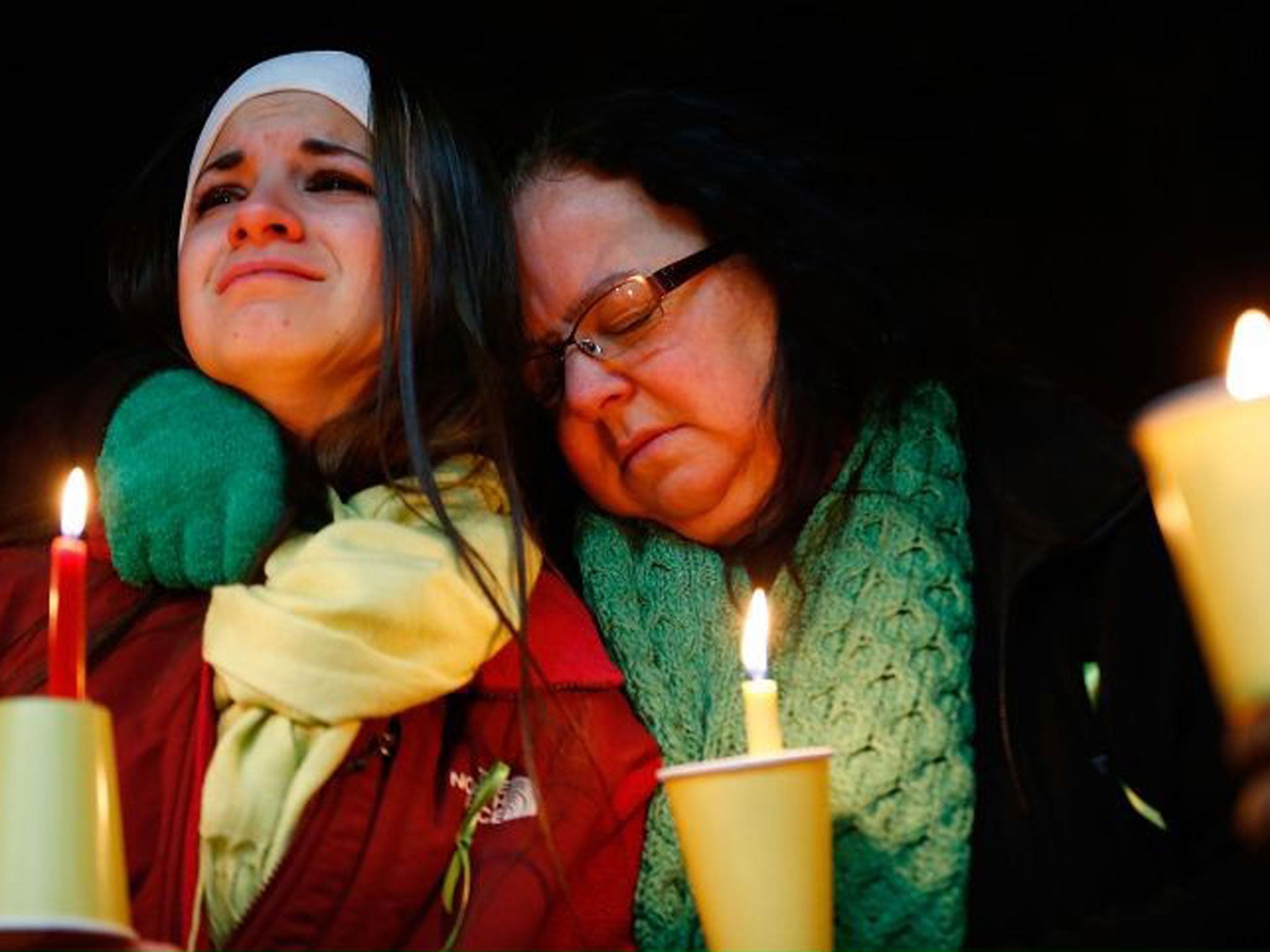 Donna Soto (R), mother of Victoria Soto, the first-grade teacher at Sandy Hook Elementary School who was shot and killed while protecting her students, hugs her daughter Karly
