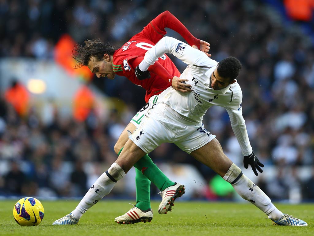 Michu battles with Sandro for the ball