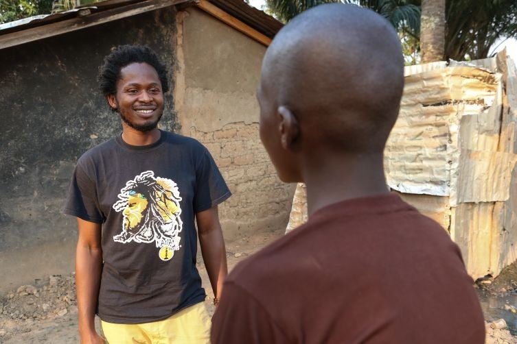 Ishmael Beah, former Sierra Leonean child soldier and UNICEF Goodwill Ambassador with Assane (15 years old), who was a child soldier, at his house in Bangui, CAR. 1st December 2012.
