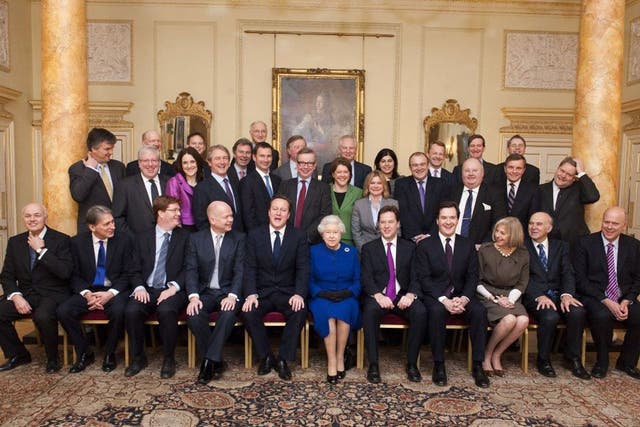 The Queen sits among members of the Cabinet today, flanked by David Cameron and Nick Clegg