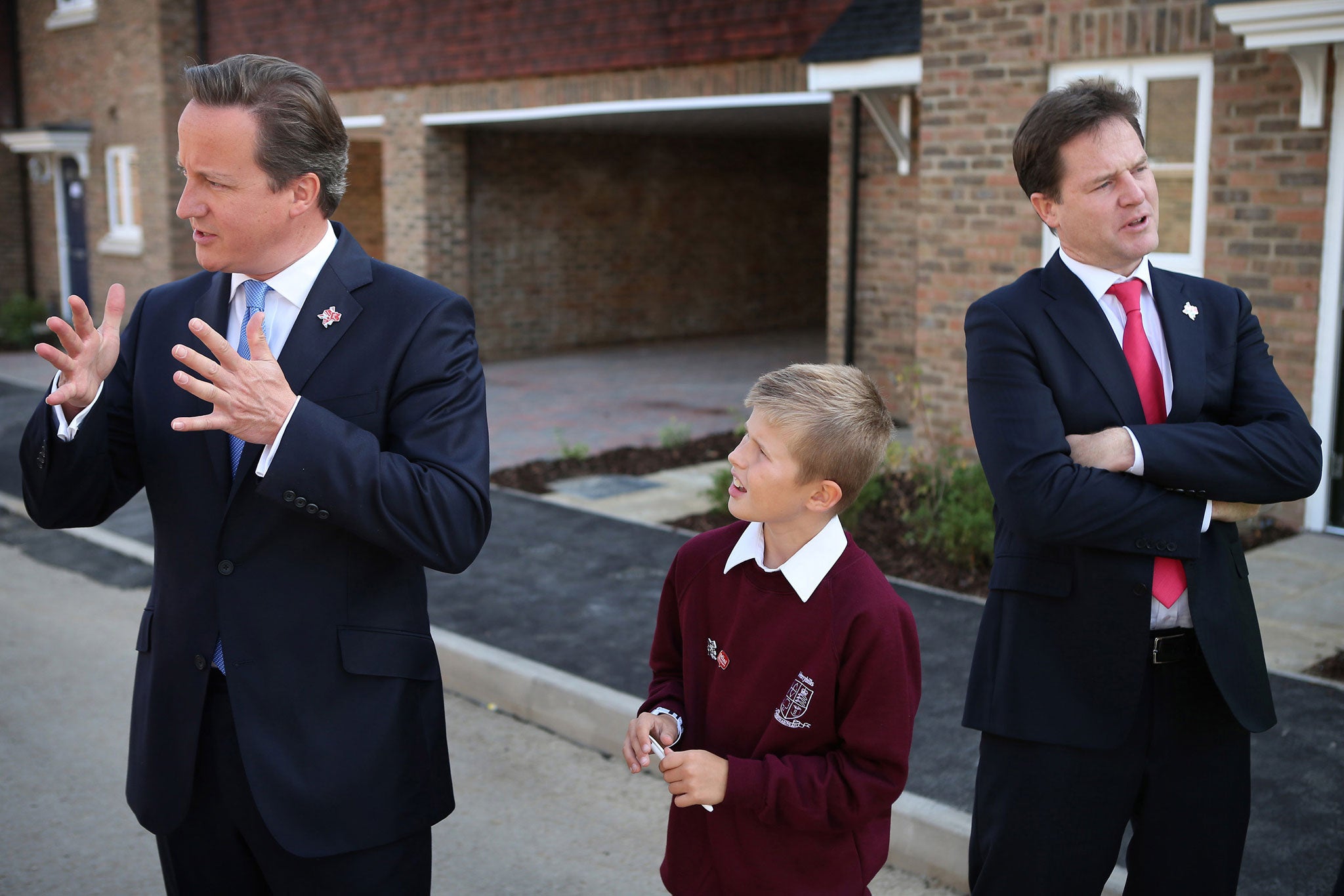 David Cameron and Nick Clegg with nine-year-old Josh Wood in Cheshunt in September