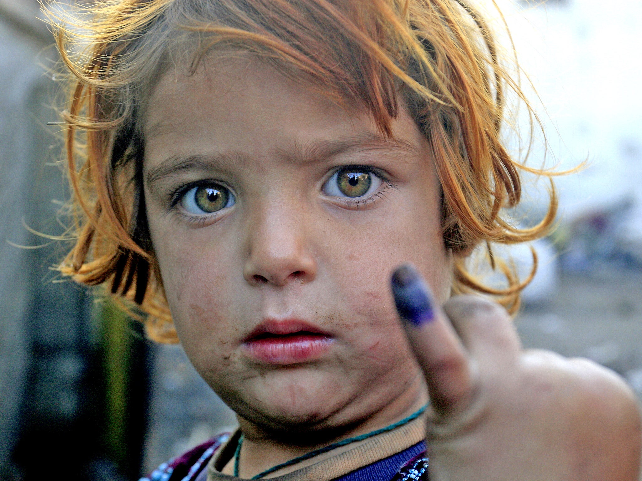 A girl with a marked finger after being immunised in Lahore