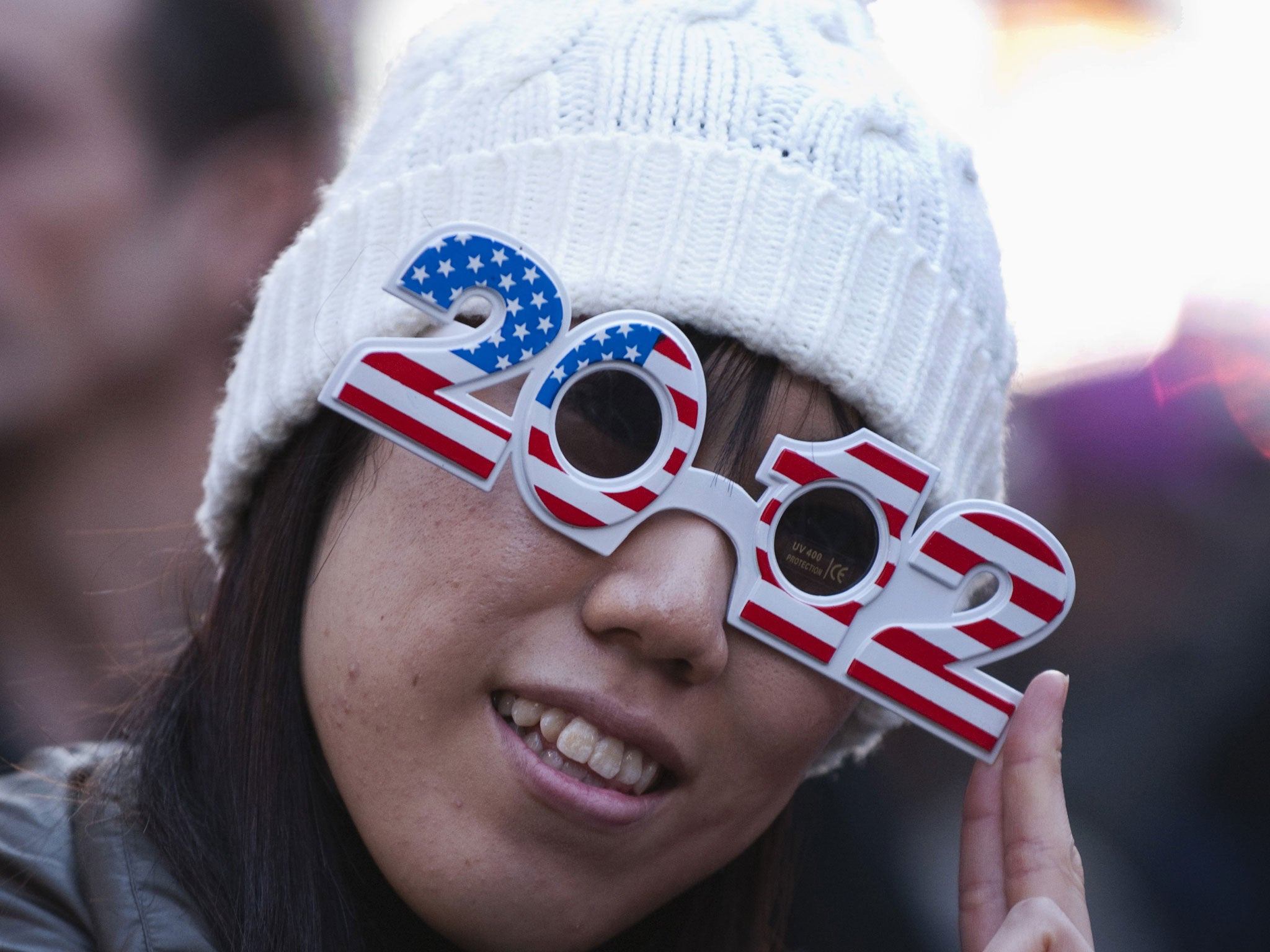 A woman wears 2012 glasses as she celebrates New Year's Eve in Times Square December 31, 2011 in New York.