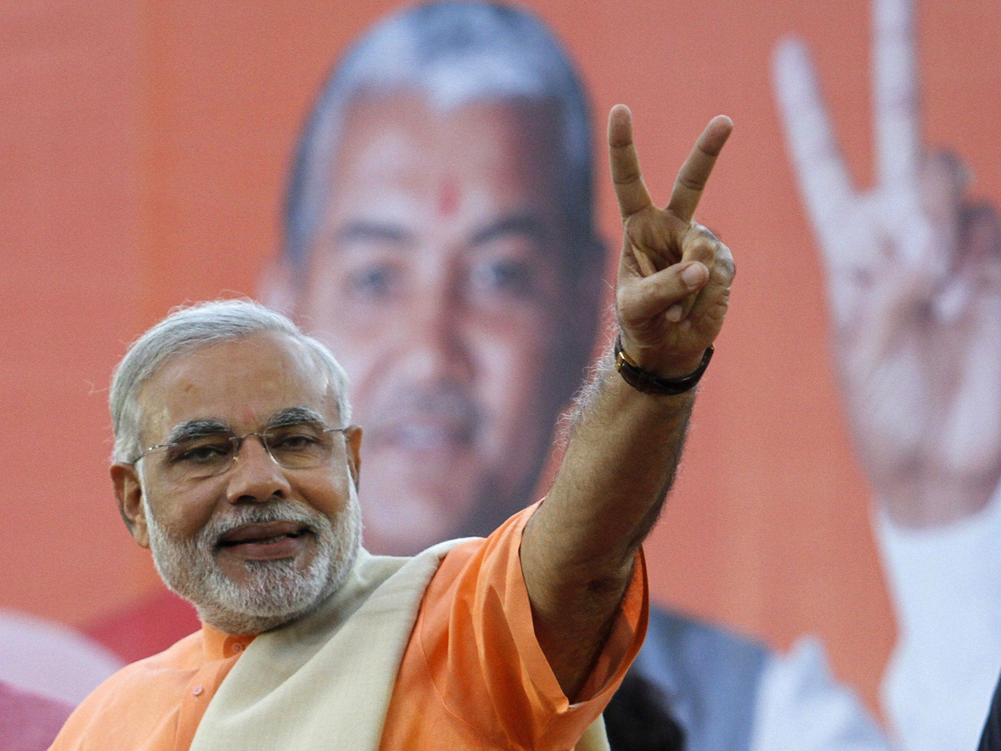 Narendra Modi, chief minister of Gujarat state, gestures on the podium