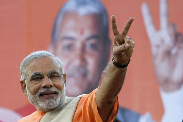 Narendra Modi, chief minister of Gujarat state, gestures on the podium 