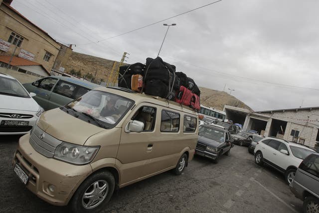 Palestinians and Syrians who fled violence in their country are seen at the Masnaa Lebanese border crossing with Syria as people stamp their documents before entering Lebanon on December 19, 2012. A large number of Palestinians refugees and others who fle