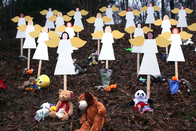 The people of Newtown mourn while police search for a motive for the massacre