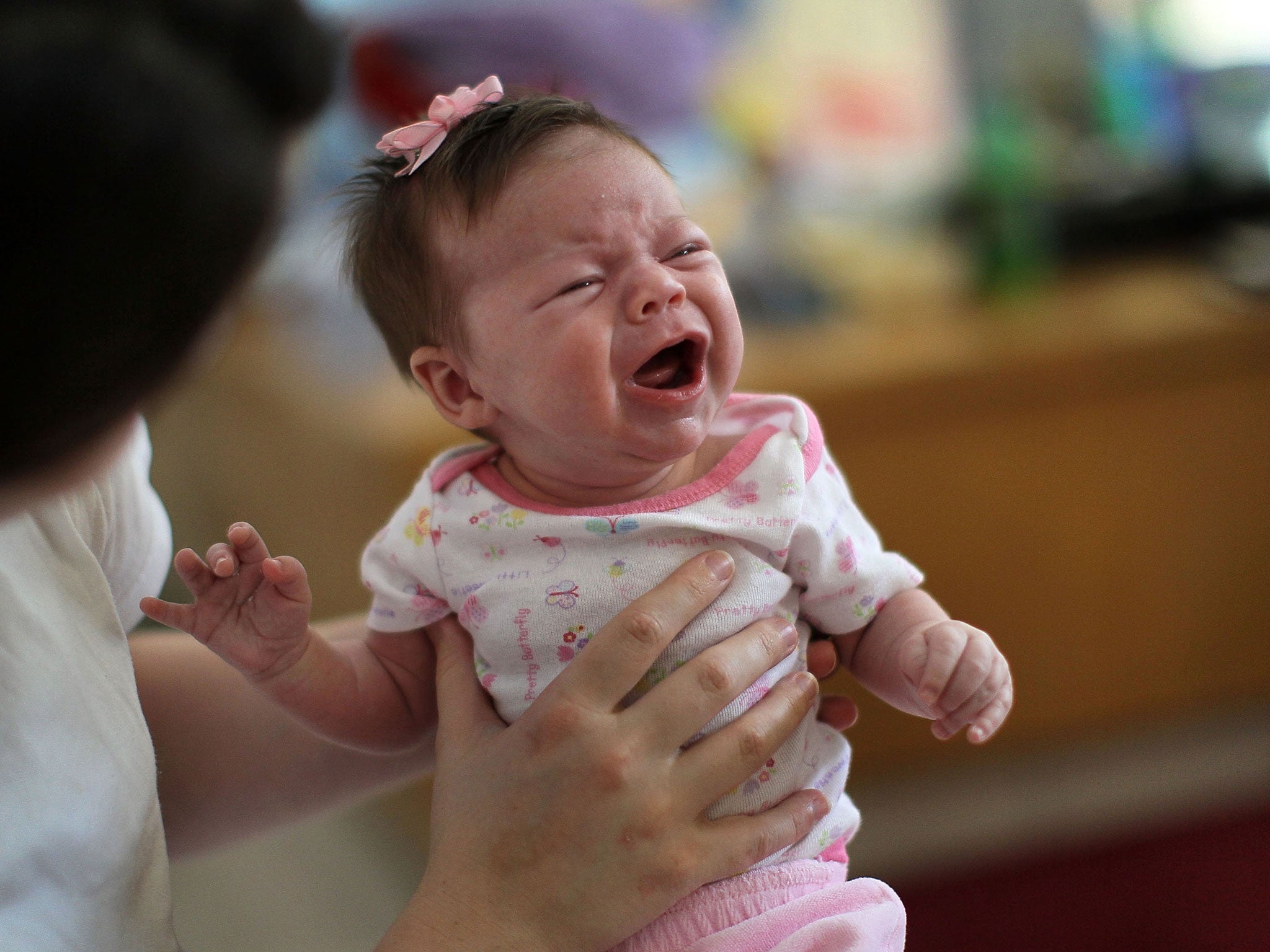 Six-week-old Lillian is held by her mother in the common area of their ward at Decatur Correctional Center February 18, 2011 in Decatur, Illinois.