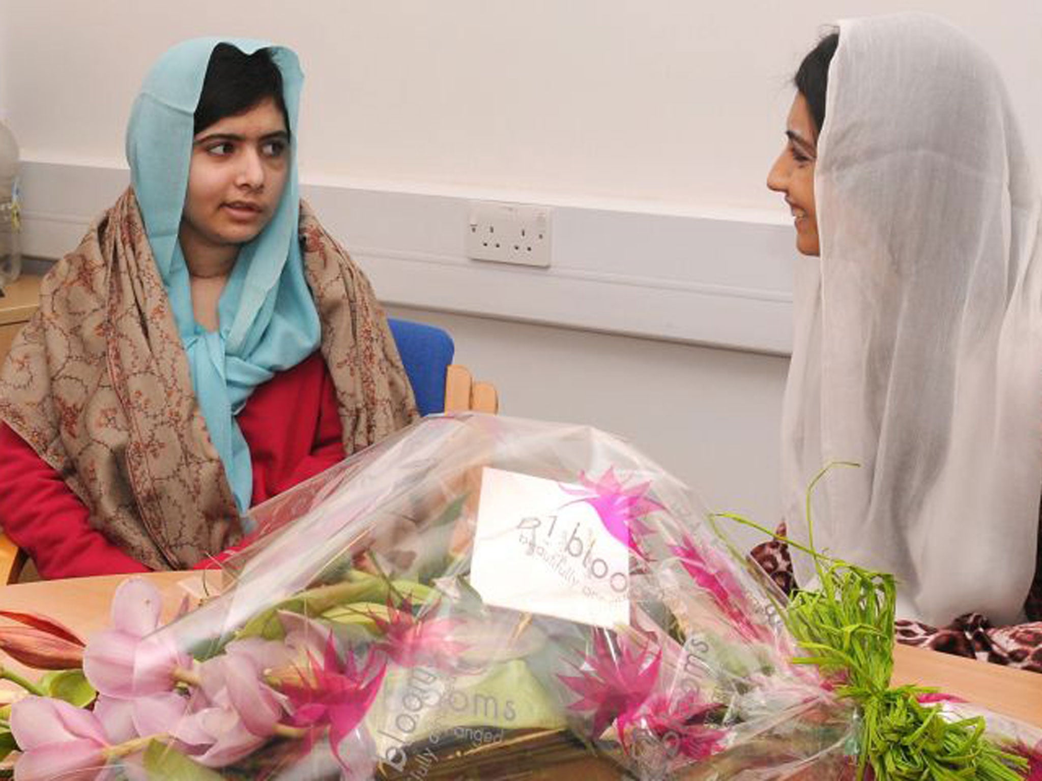Malala Yousafzai, left, is visited by the Pakistani president’s daughter, Asifa Bhutto, in hospital in Birmingham