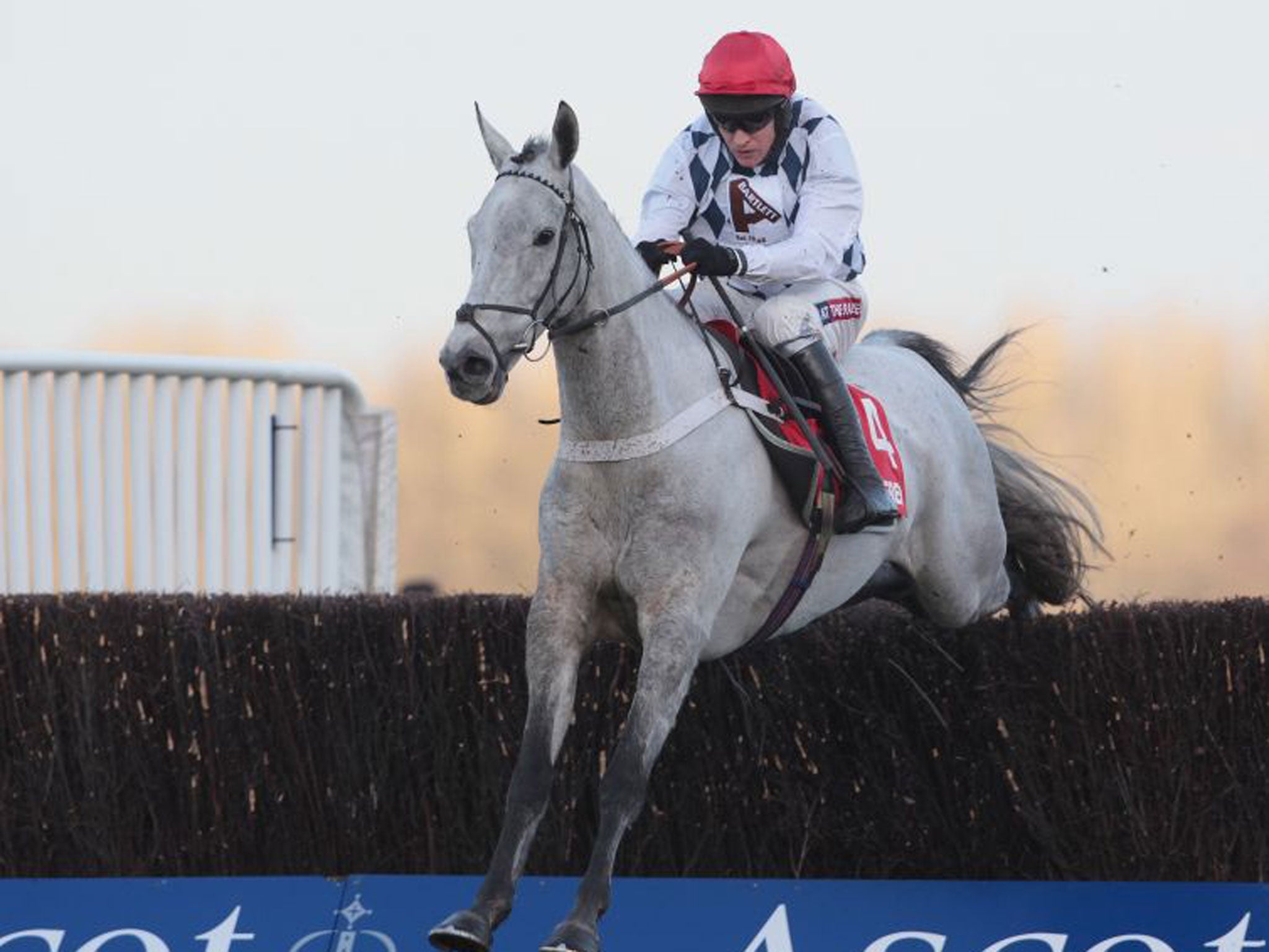 Simonsig, ridden by Barry Geraghty, clears the last to win the Noel Novices Chase at Ascot yesterday