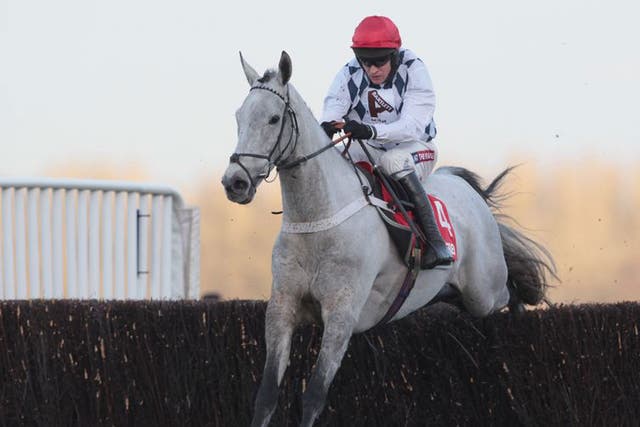 Simonsig, ridden by Barry Geraghty, clears the last to win the Noel Novices Chase at Ascot yesterday