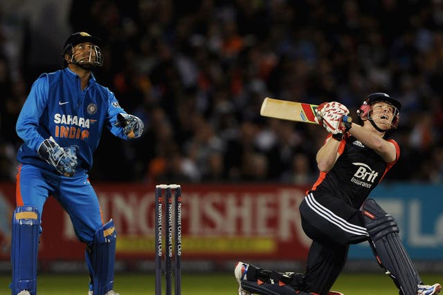 Eoin Morgan of England bats watched by Indian wicketkeeper MS Dhoni