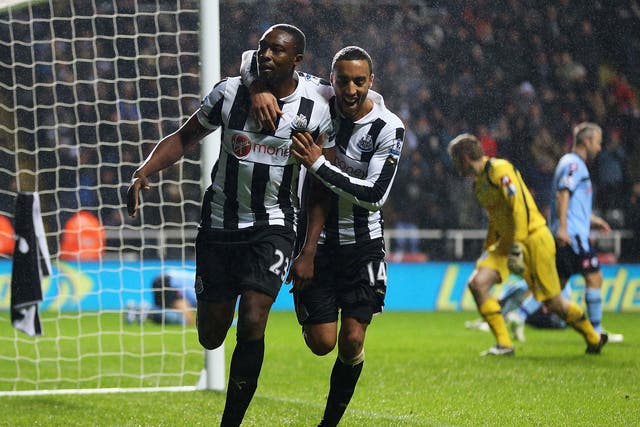 Shola Ameobi of Newcastle celebrates his goal with James Perch