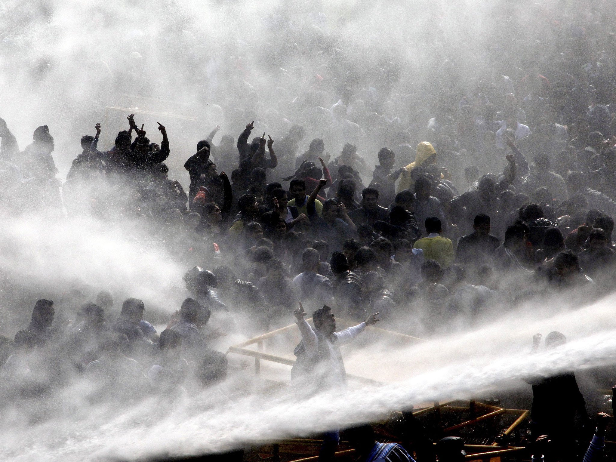 Outrage: Police use water cannon against protesters in Delhi yesterday