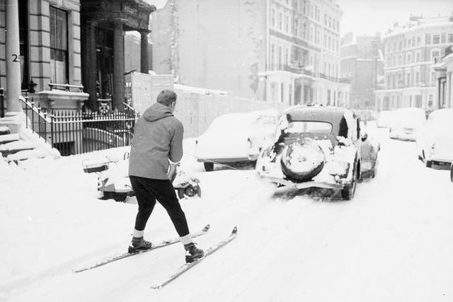 A skier being towed through Earls Court in December 1962