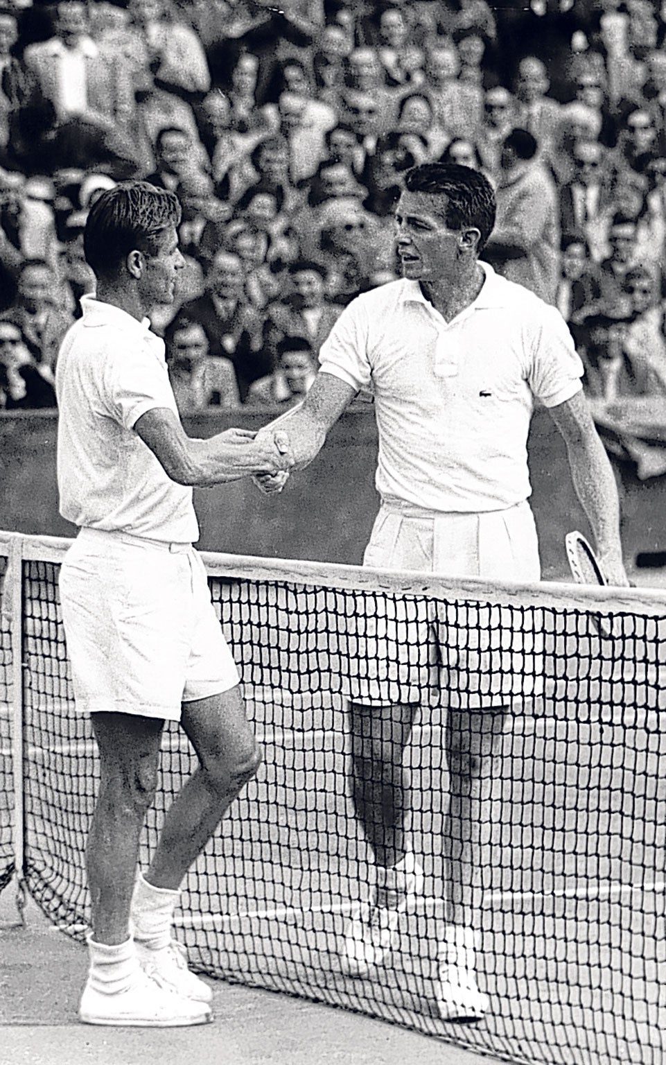 Larsen, right, shakes hands with his fellow-American Tony Trabert after losing to him in the final of the 1954 French Open 