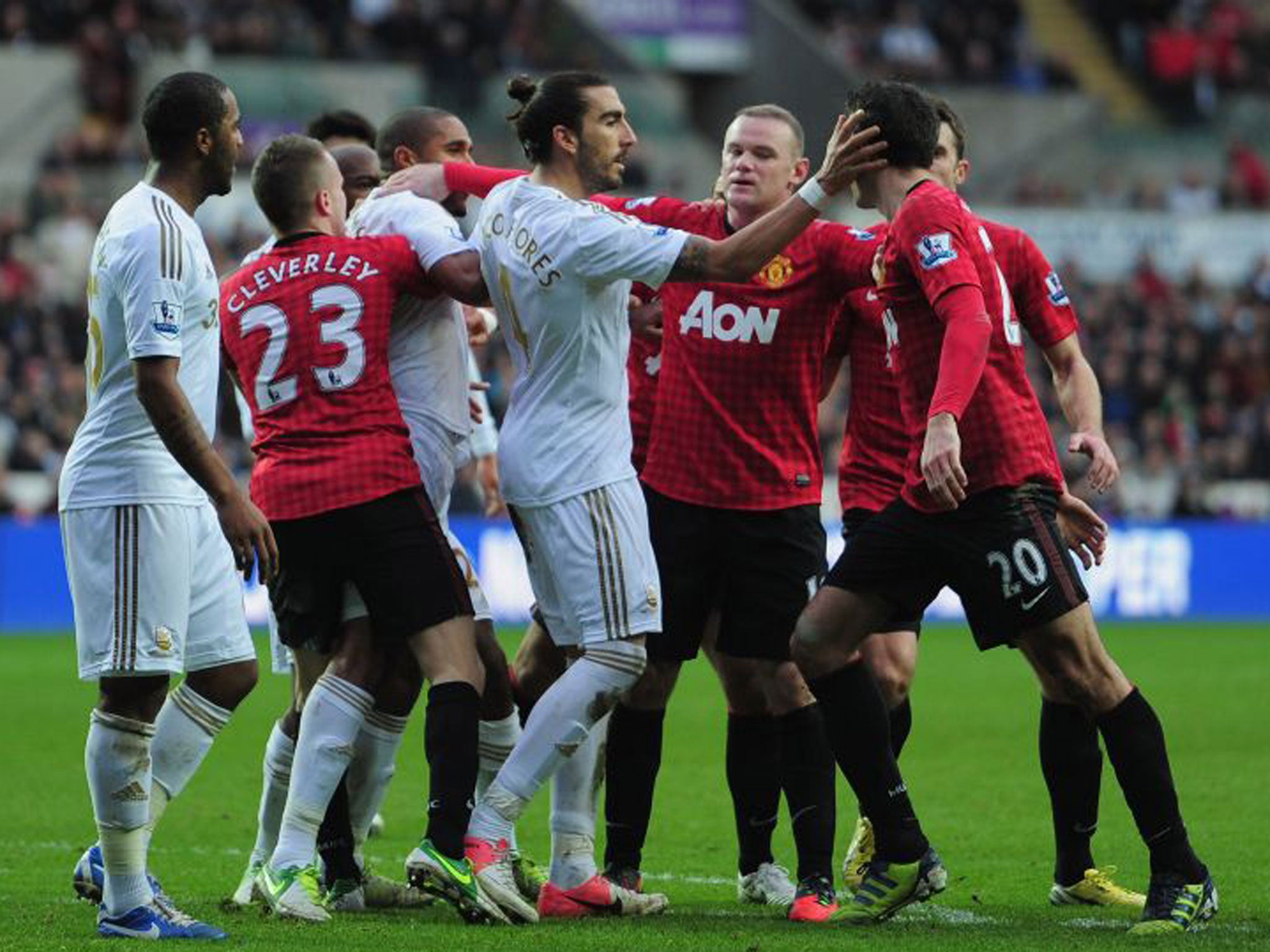 Robin van Persie (right) has to be held back from Ashley Williams (third left)