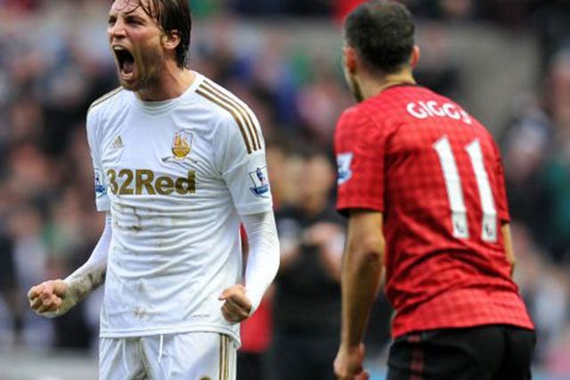 Michu celebrates his equaliser for Swansea yesterday